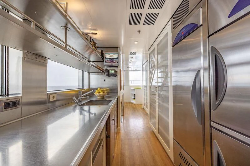 a large kitchen with stainless steel appliances aboard FELIX Yacht for Sale