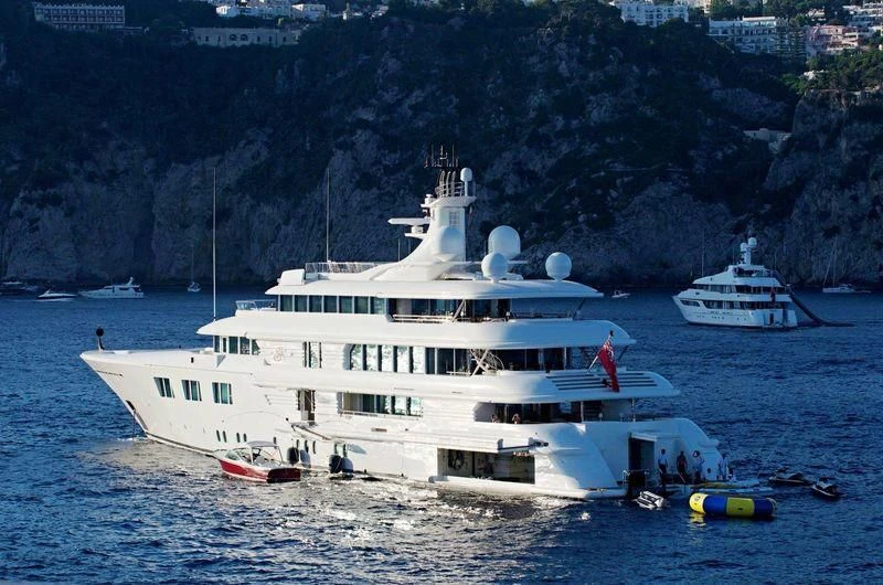a large white boat with a few people on it aboard FELIX Yacht for Sale