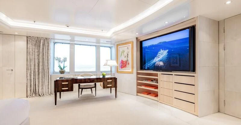 a room with a tv and a table aboard FELIX Yacht for Sale