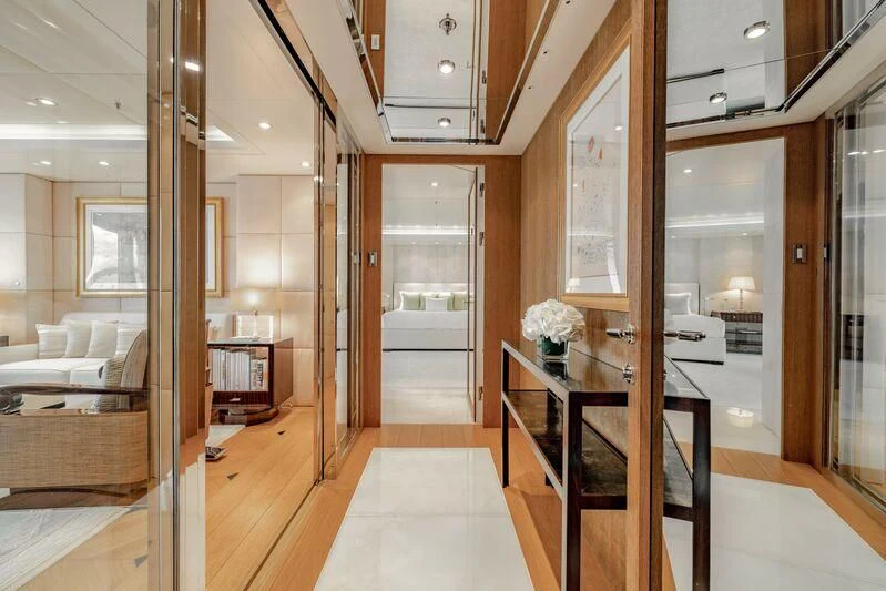 a room with a wood floor and a table with chairs and a wood floor aboard FELIX Yacht for Sale