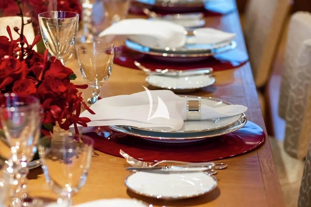 a plate with a knife and fork on it aboard FELIX Yacht for Sale