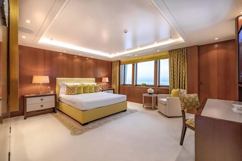 a bedroom with a bed and a table aboard FELIX Yacht for Sale