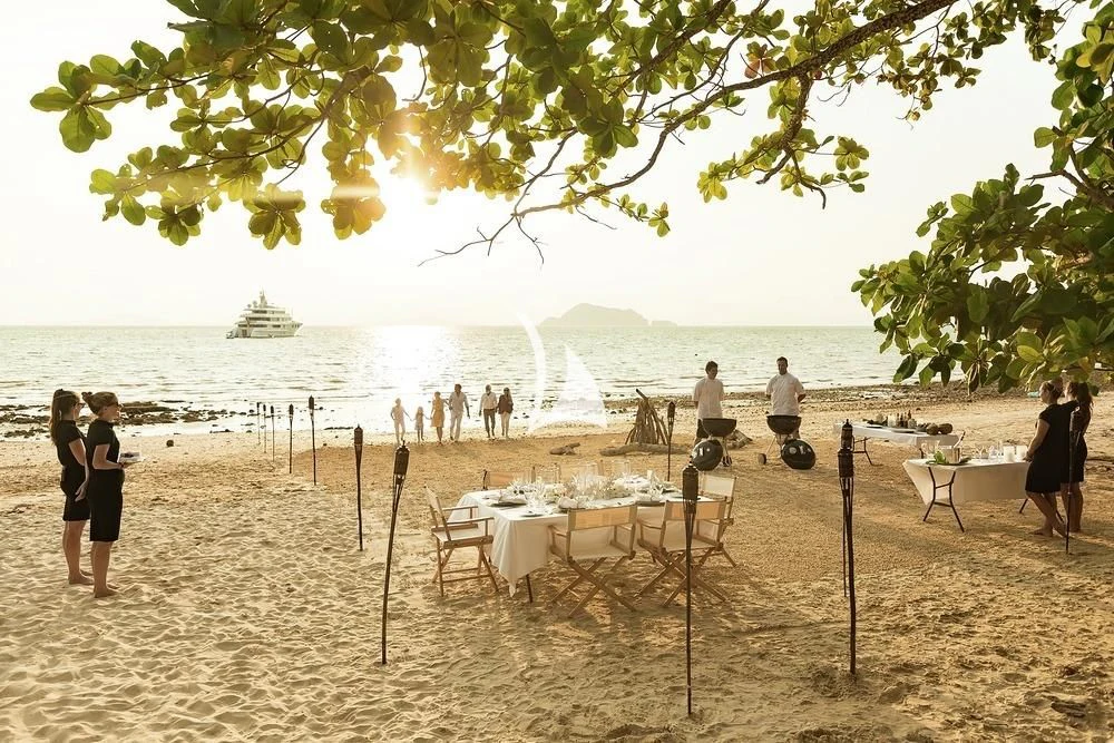 a group of people on a beach aboard FELIX Yacht for Sale