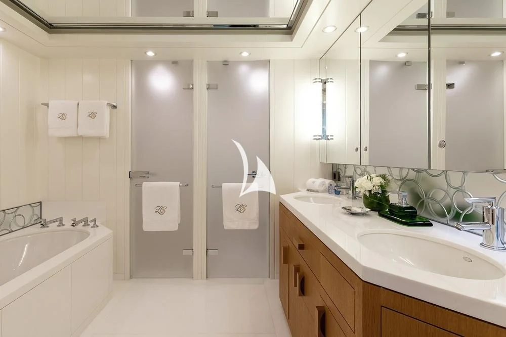 a bathroom with a shower sink and a bathtub aboard FELIX Yacht for Sale