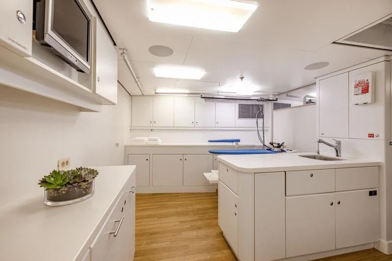 a kitchen with white cabinets aboard FELIX Yacht for Sale