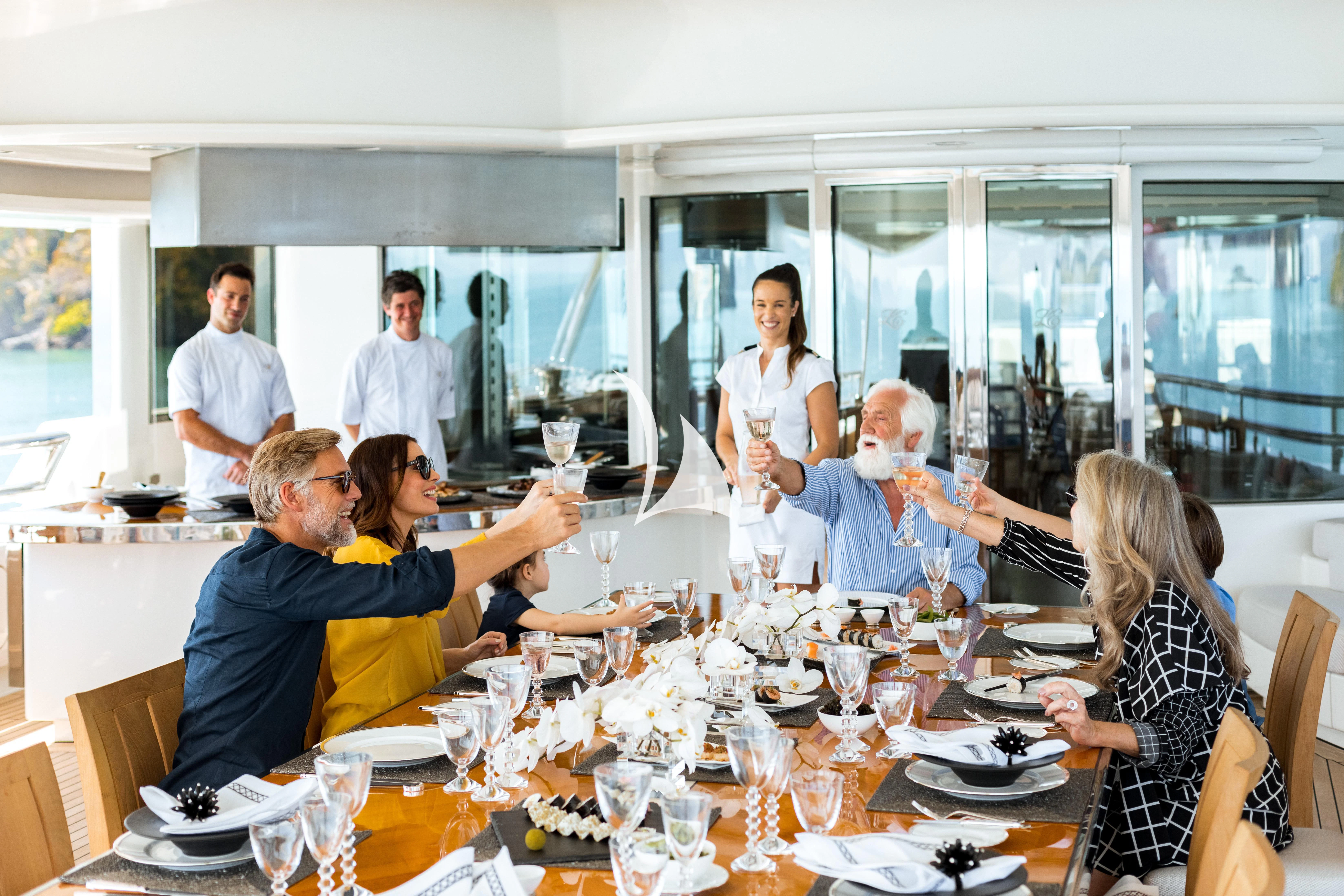 a group of people at a table aboard FELIX Yacht for Sale
