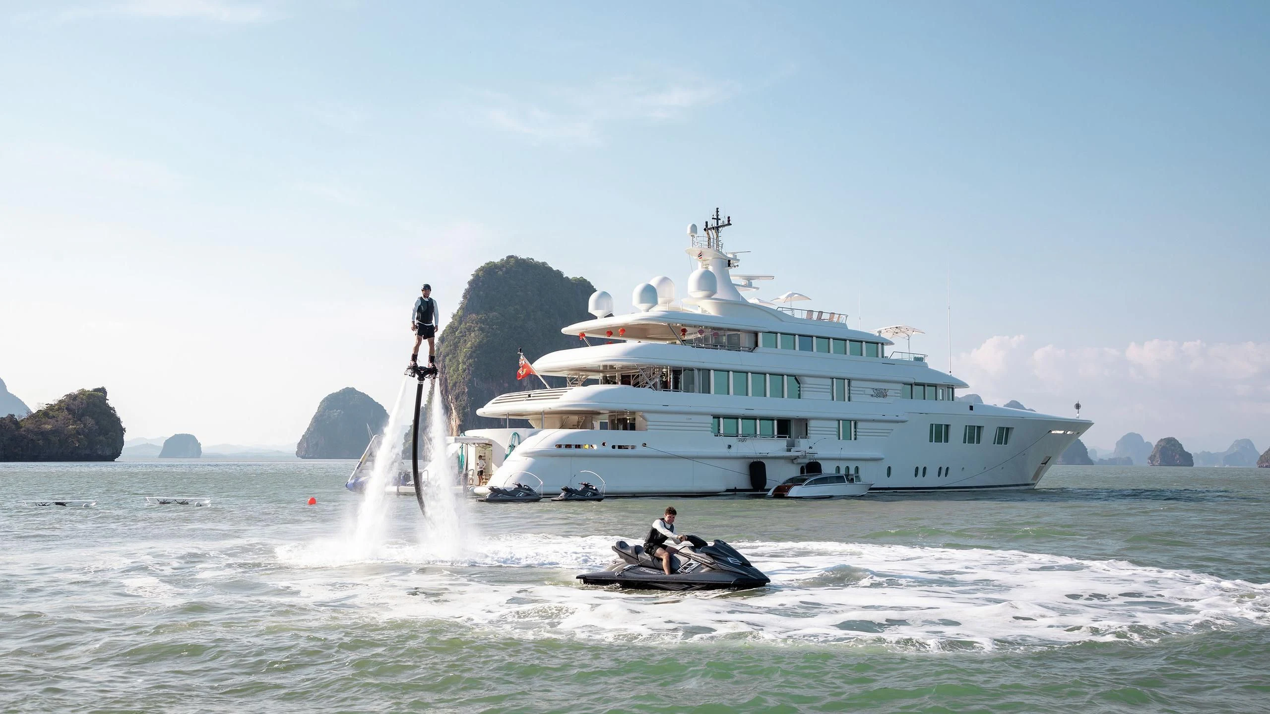 a boat with a ladder and a boat in the water aboard FELIX Yacht for Sale