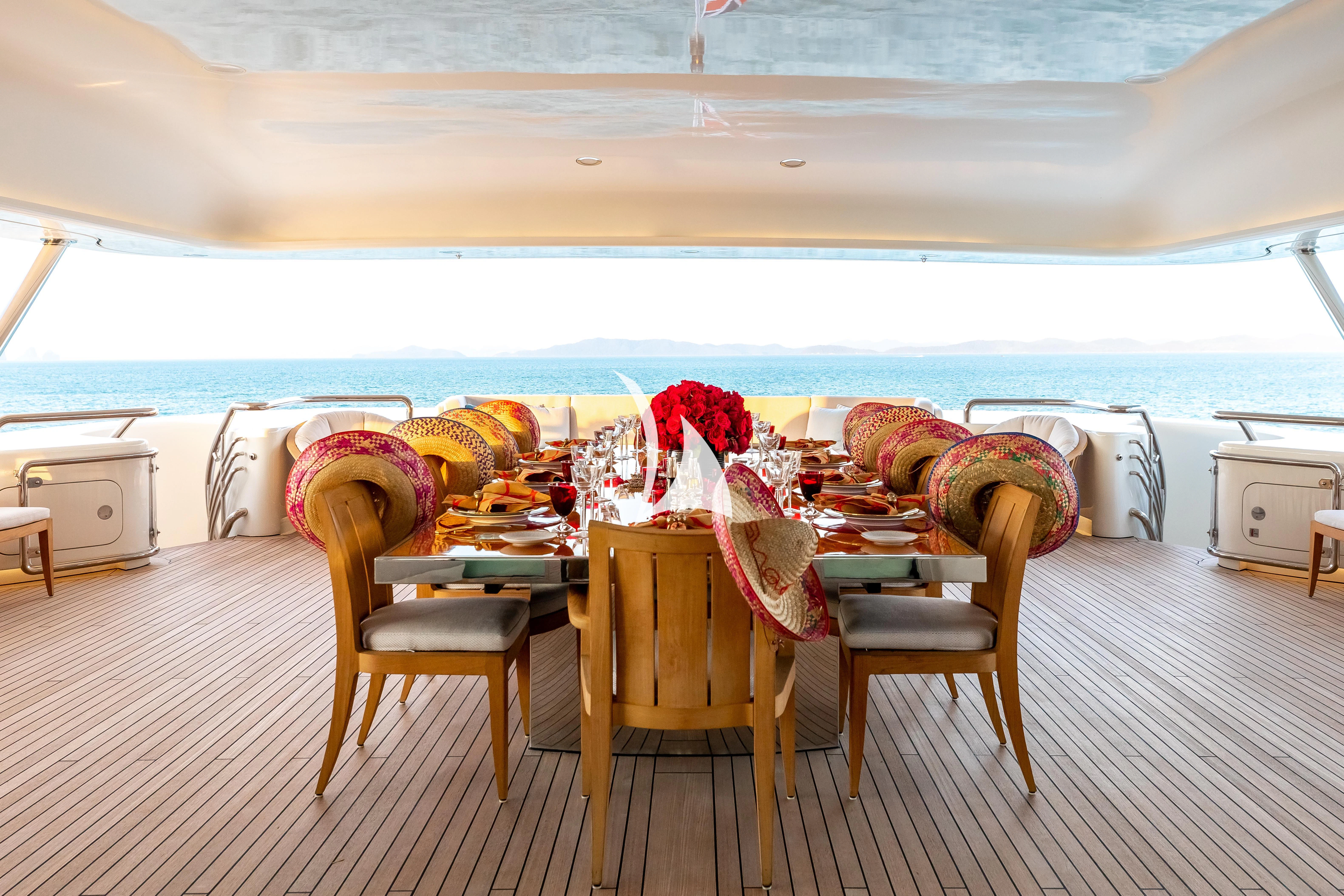 a table and chairs on a balcony aboard FELIX Yacht for Sale