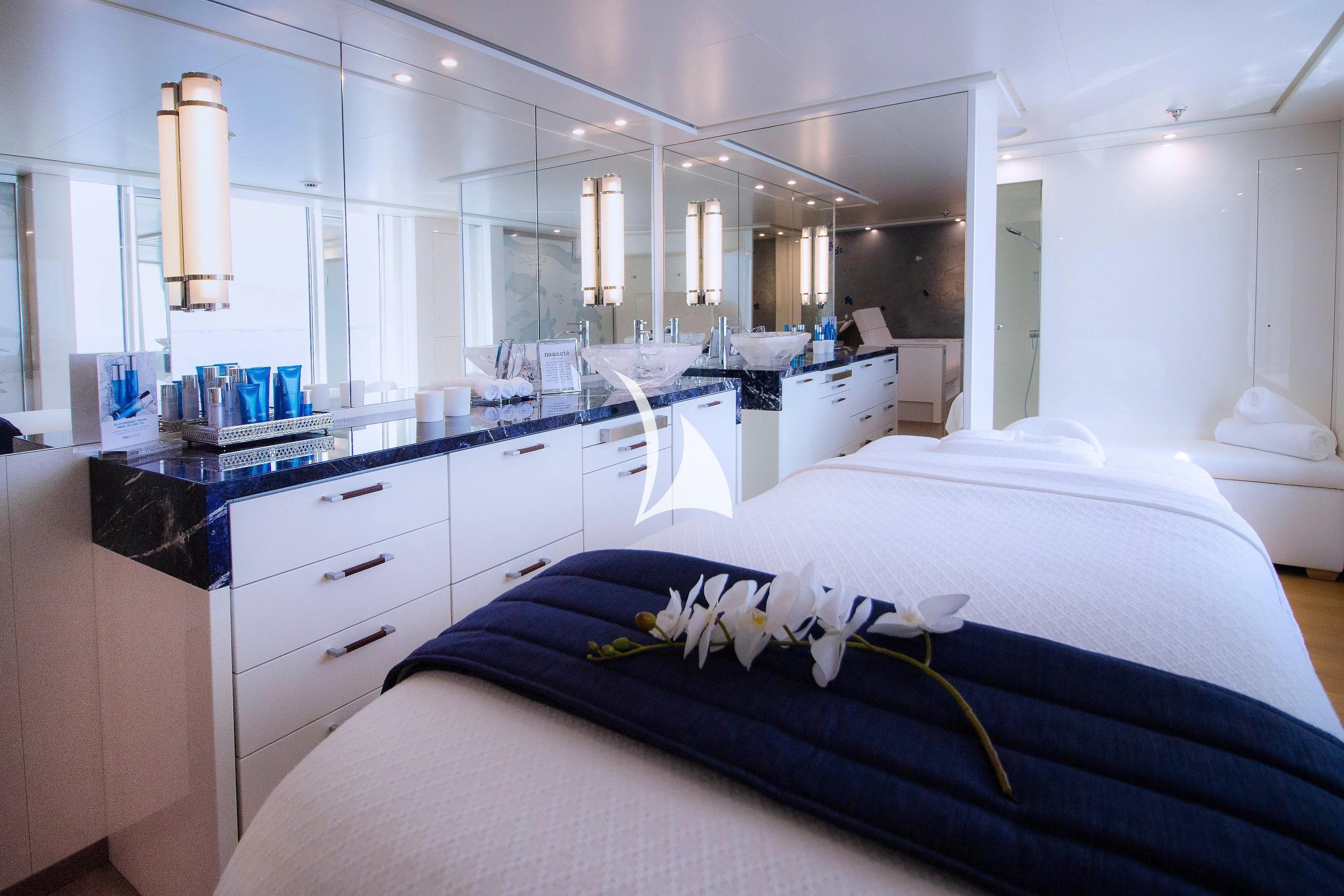 a bedroom with a bed and a desk aboard FELIX Yacht for Sale