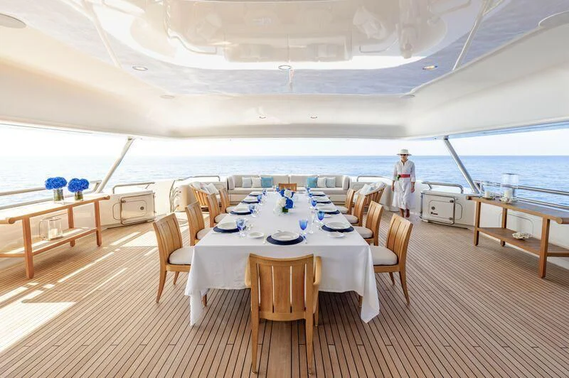 a room with tables and chairs aboard FELIX Yacht for Sale
