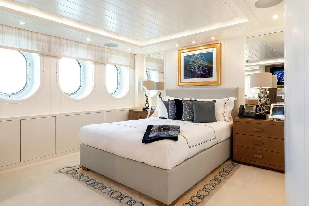 a bedroom with a bed and a desk aboard FELIX Yacht for Sale