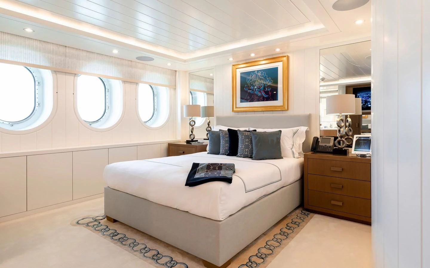 a bedroom with a bed and a desk aboard FELIX Yacht for Sale