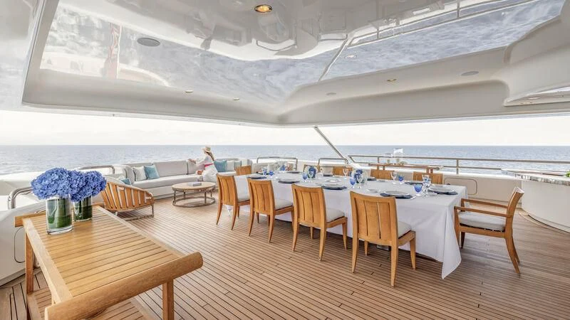 a room with tables and chairs aboard FELIX Yacht for Sale
