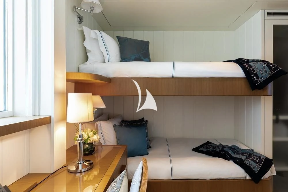 a bedroom with a bed and a table aboard FELIX Yacht for Sale