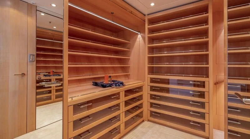 a room with a shelf and a shelf with books aboard FELIX Yacht for Sale
