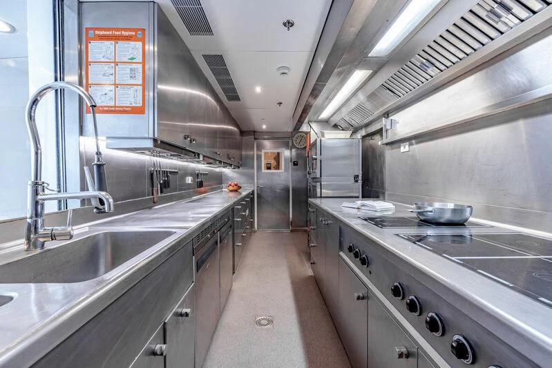 a kitchen with stainless steel appliances aboard FELIX Yacht for Sale
