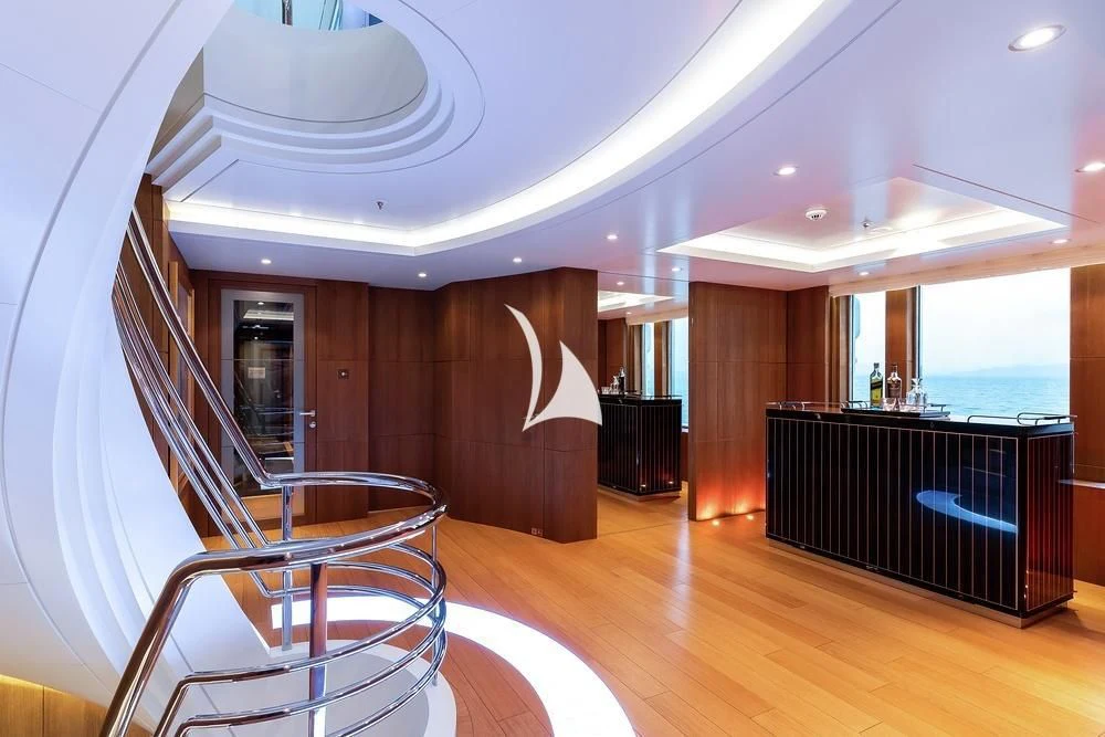 a room with a staircase and a table and chairs aboard FELIX Yacht for Sale