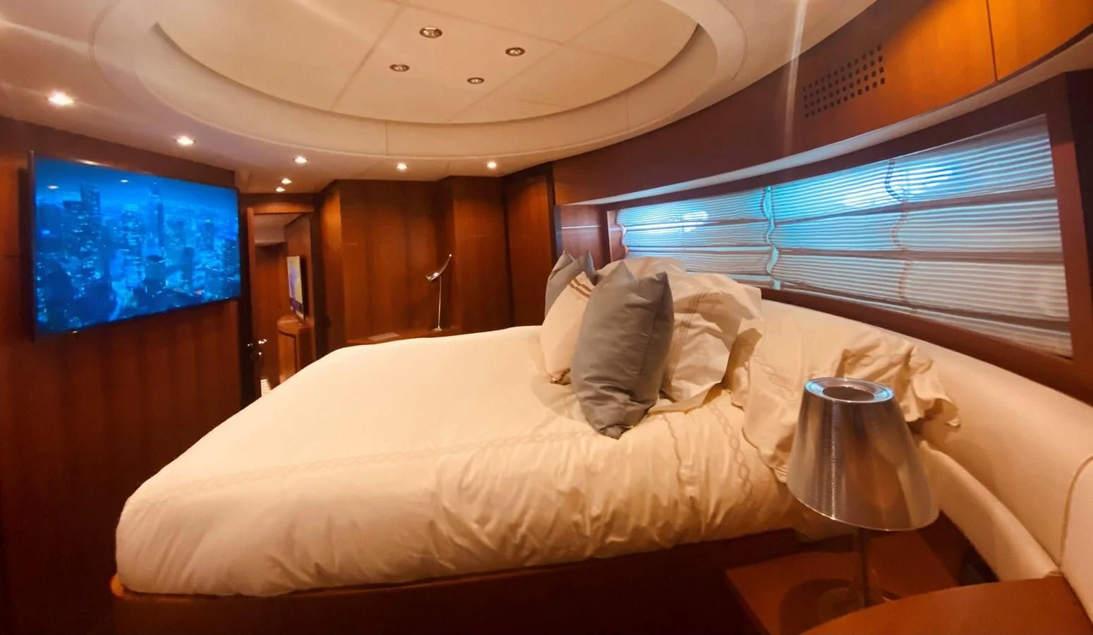 a bed with a white bed spread aboard ROMPEMAR Yacht for Sale