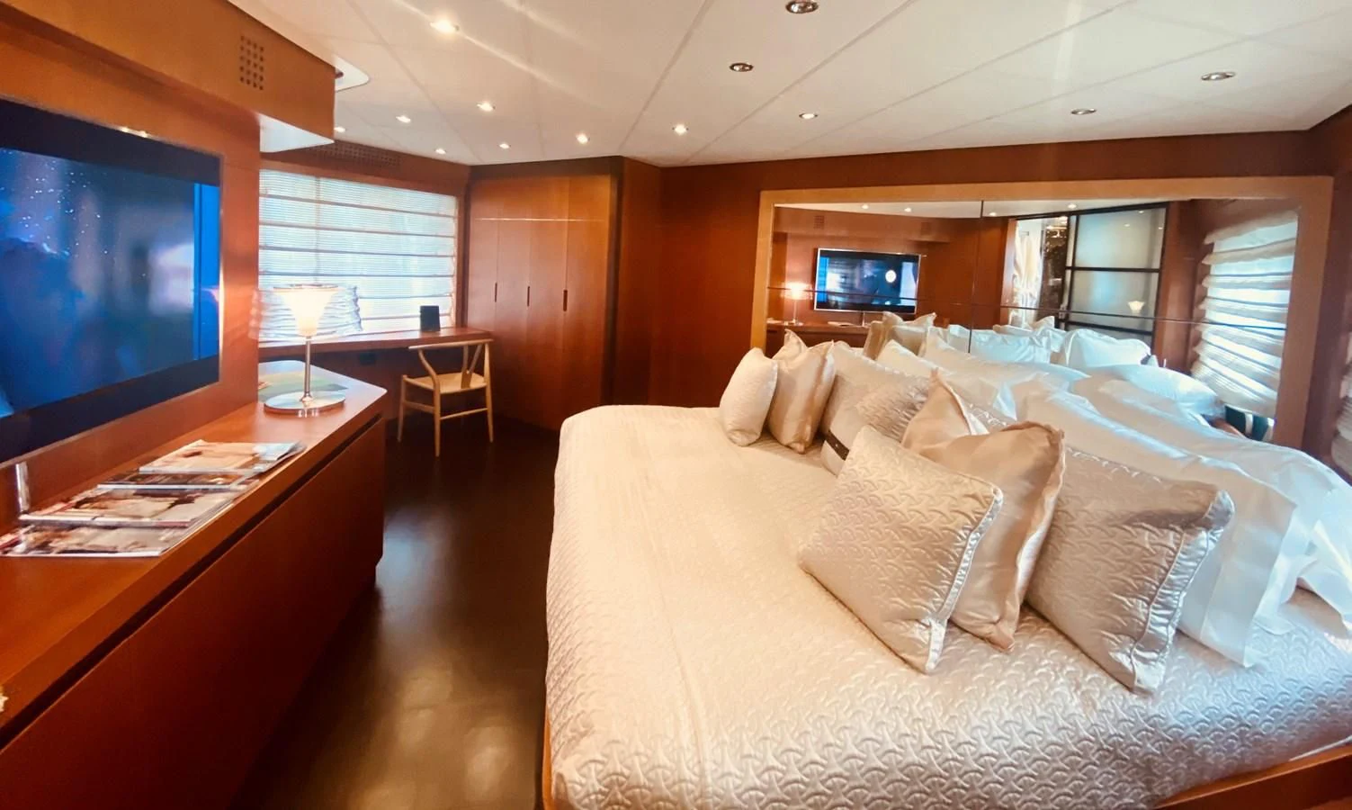 a hotel room with a bed and a tv aboard ROMPEMAR Yacht for Sale