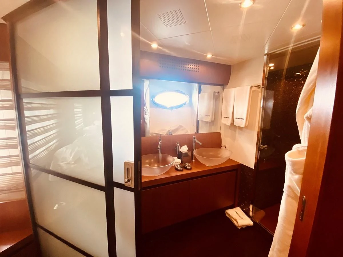 a bathroom with a large mirror aboard ROMPEMAR Yacht for Sale