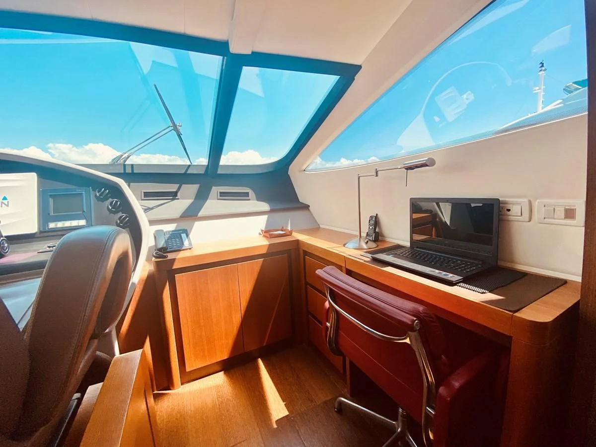 a room with a desk and a laptop aboard ROMPEMAR Yacht for Sale