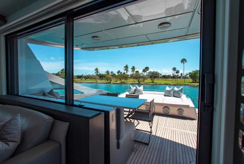 a room with a pool and a view of the water aboard LADY K Yacht for Sale
