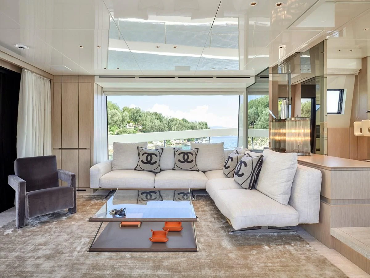 a living room with a couch and a coffee table aboard ZILVAR IV Yacht for Sale