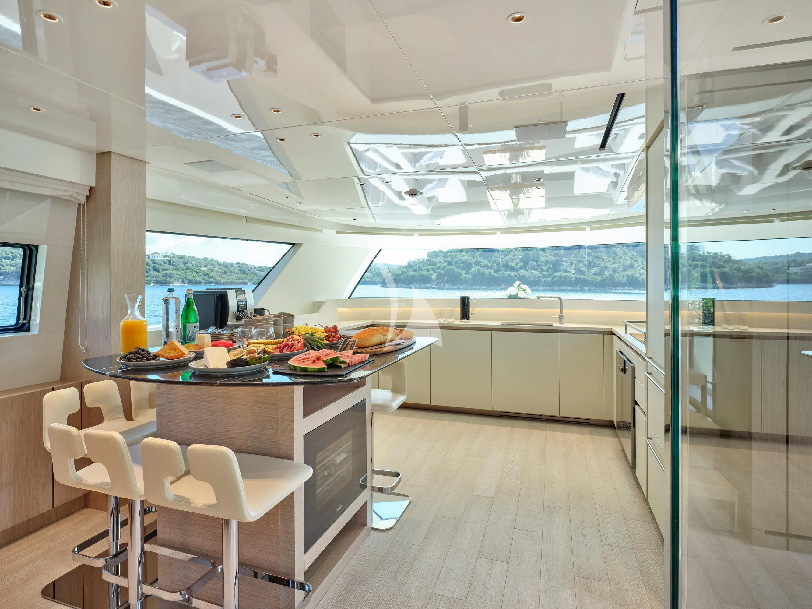 a kitchen with a table and chairs aboard ZILVAR IV Yacht for Sale