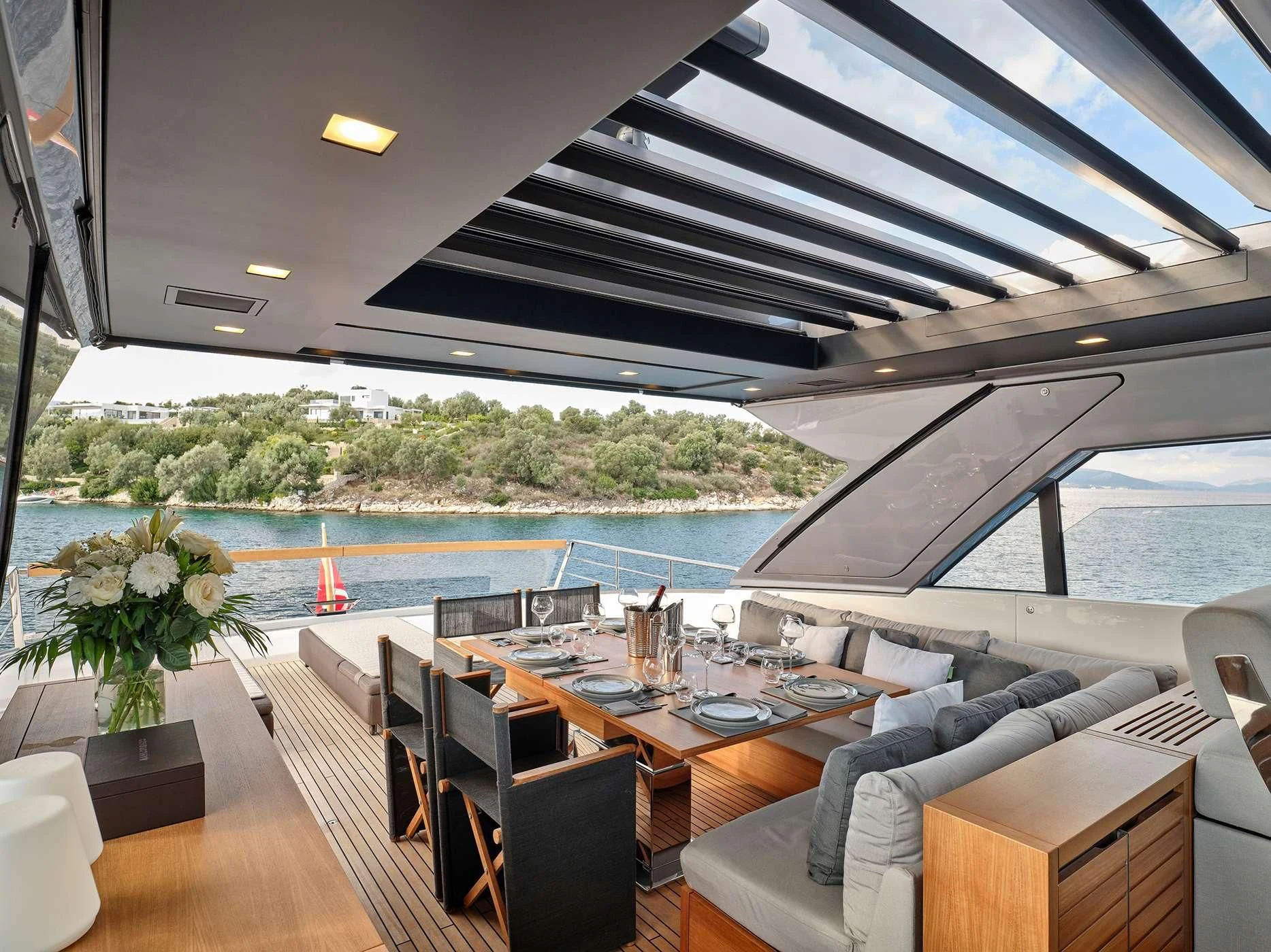 a room with a table chairs and plants and a large body of water aboard ZILVAR IV Yacht for Sale