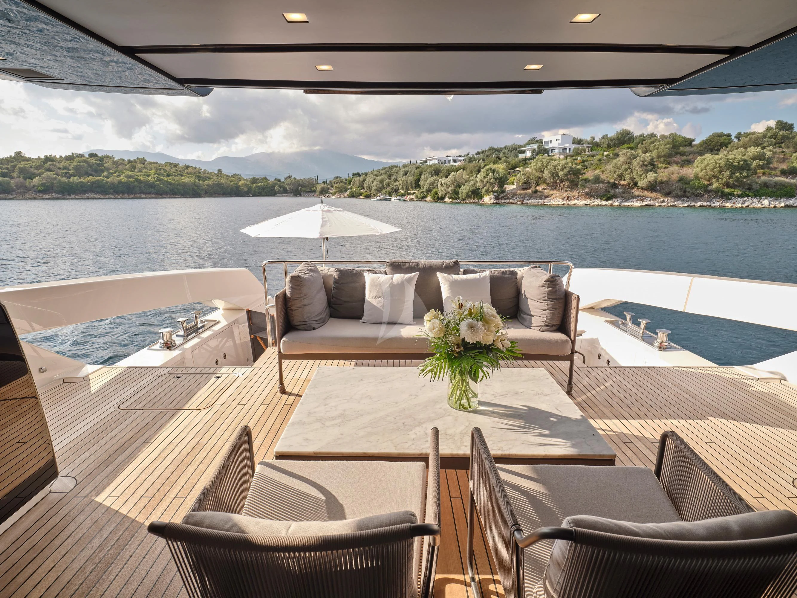a patio with a table and chairs on it aboard ZILVAR IV Yacht for Sale