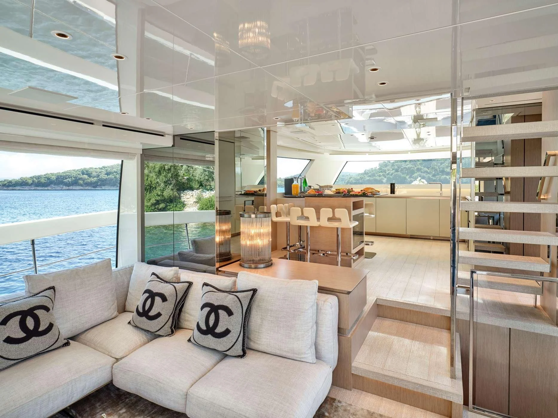 a living room with a glass wall aboard ZILVAR IV Yacht for Sale