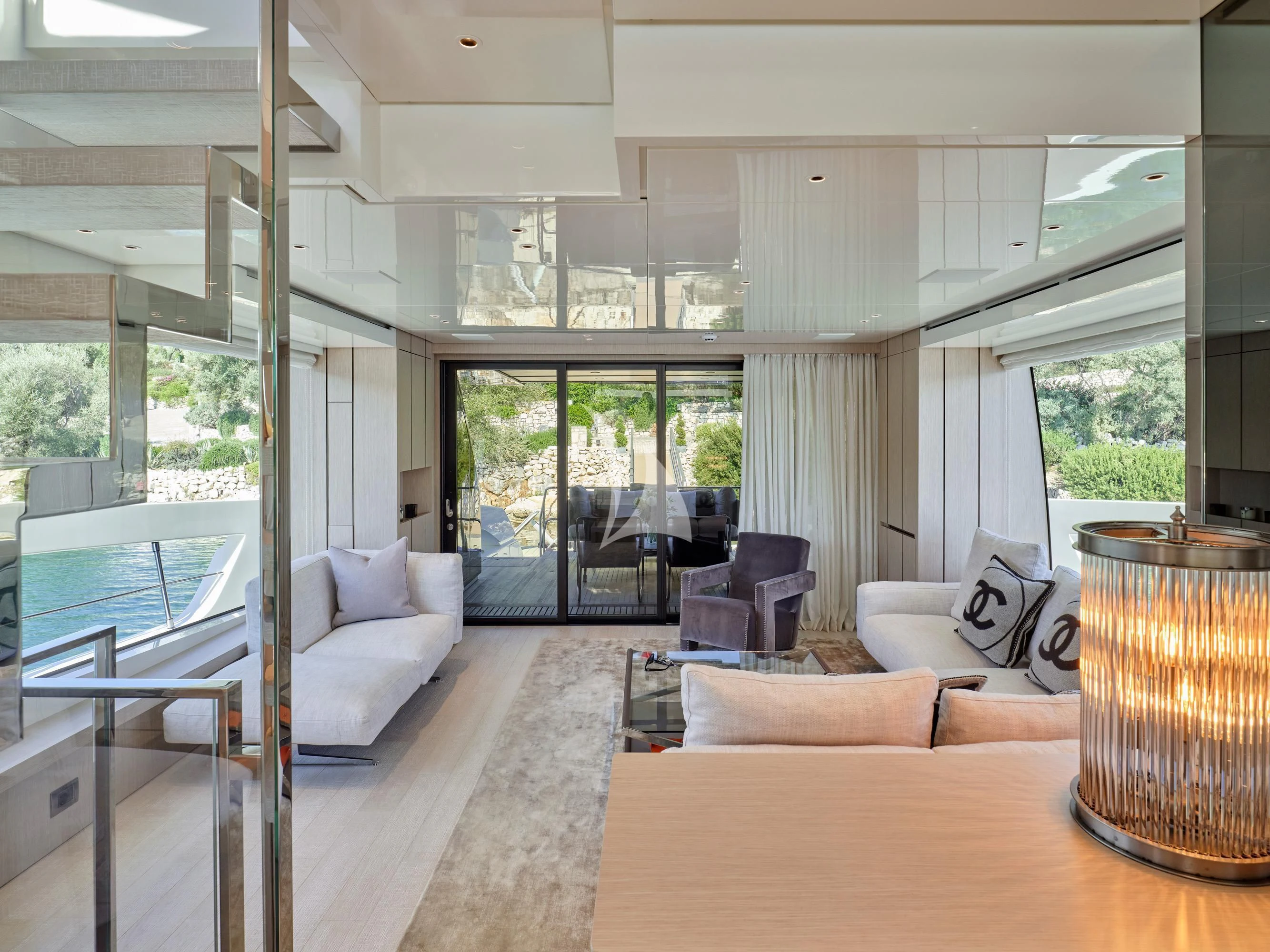 a living room with a large glass door aboard ZILVAR IV Yacht for Sale