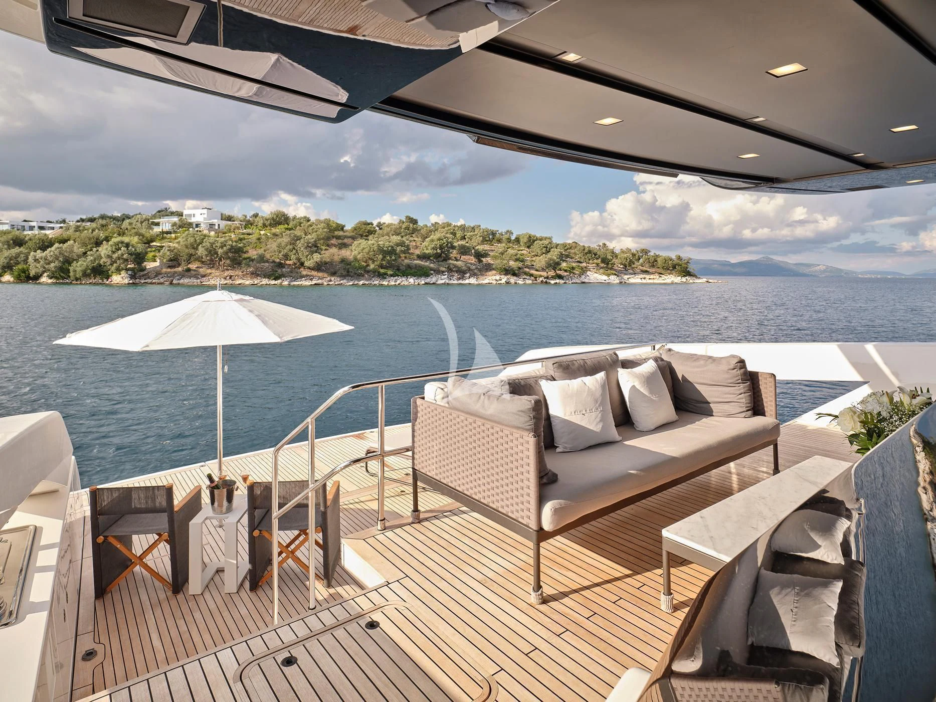 a deck with chairs and an umbrella aboard ZILVAR IV Yacht for Sale