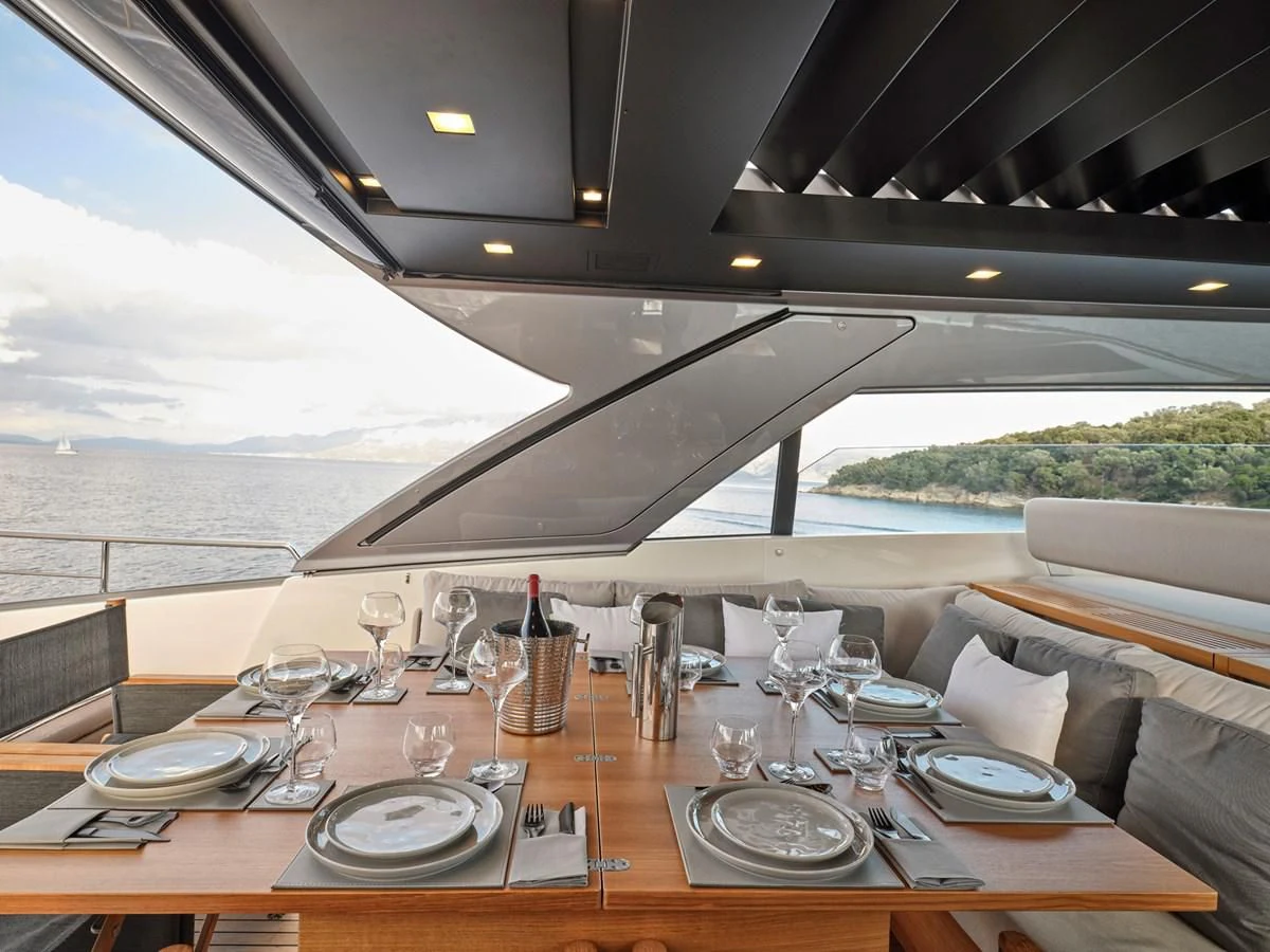 a table with plates and glasses aboard ZILVAR IV Yacht for Sale