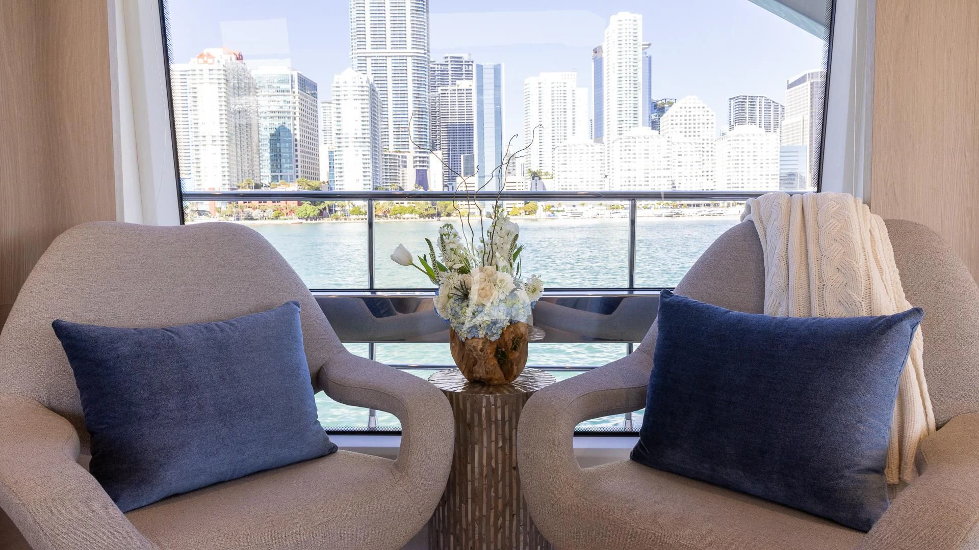 a room with a table and a vase with flowers on it aboard CAPTAIN MORGAN II Yacht for Sale