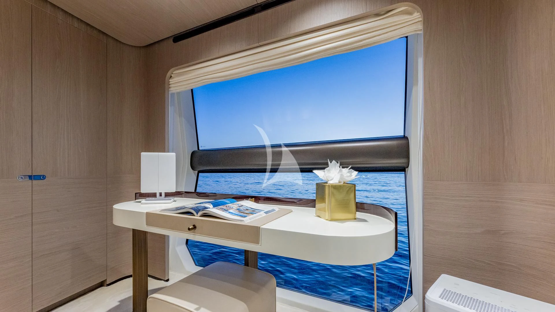 a desk with a computer and a window aboard CAPTAIN MORGAN II Yacht for Sale