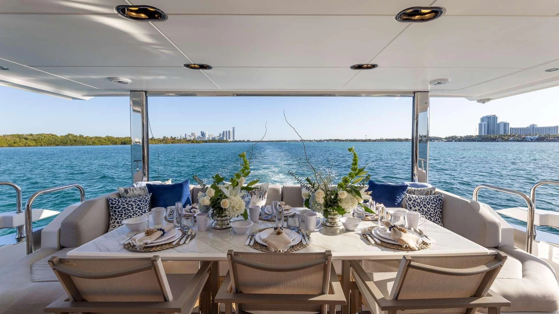 a table set for a dinner on a boat aboard CAPTAIN MORGAN II Yacht for Sale