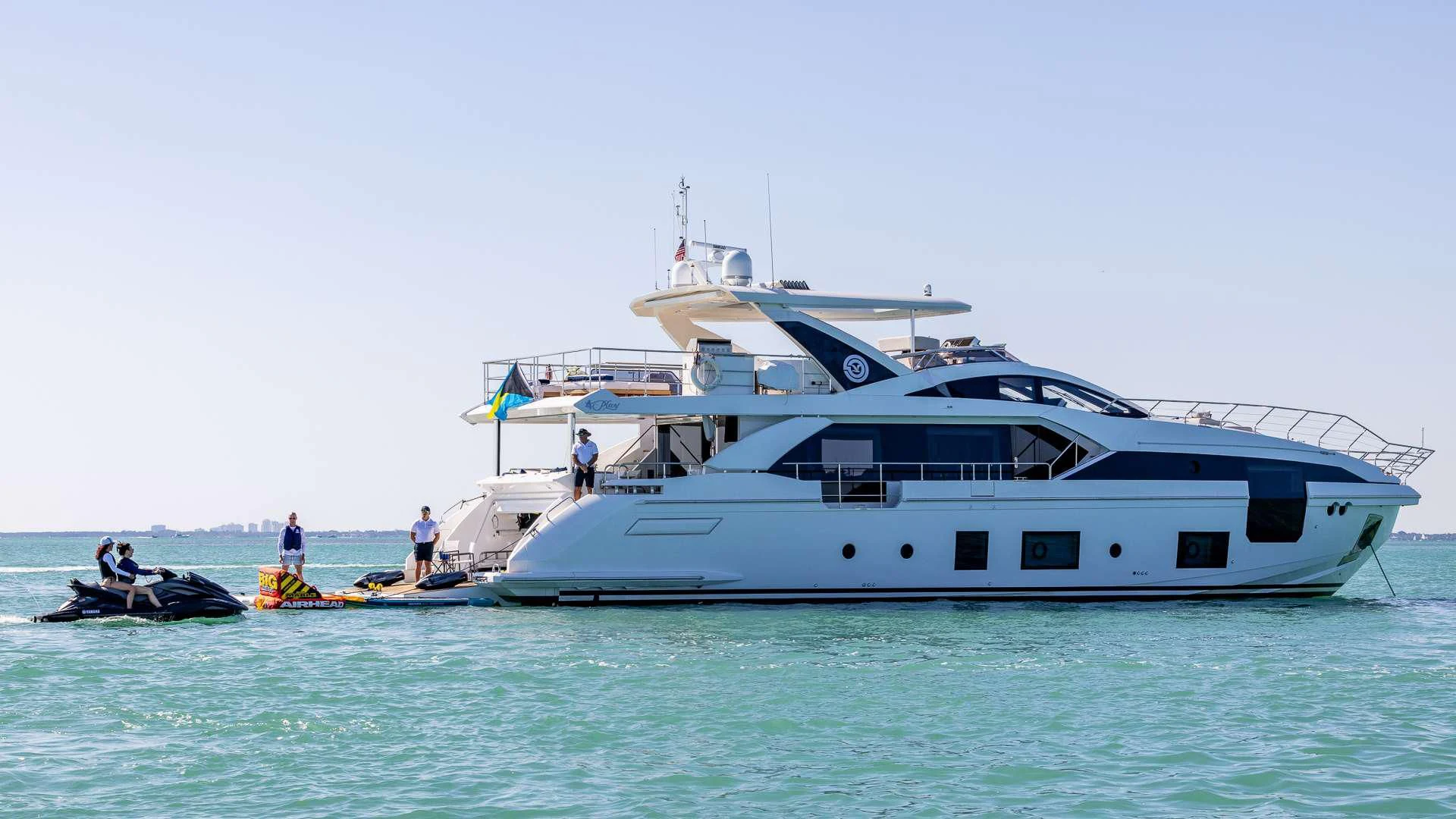 a large white boat with a couple of people on it aboard CAPTAIN MORGAN II Yacht for Sale