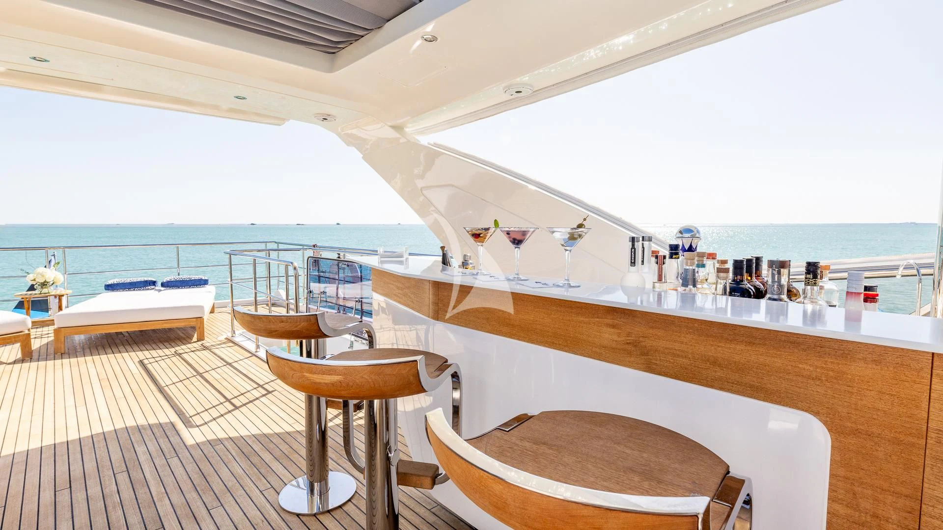 a room with a bar and a table and chairs aboard CAPTAIN MORGAN II Yacht for Sale