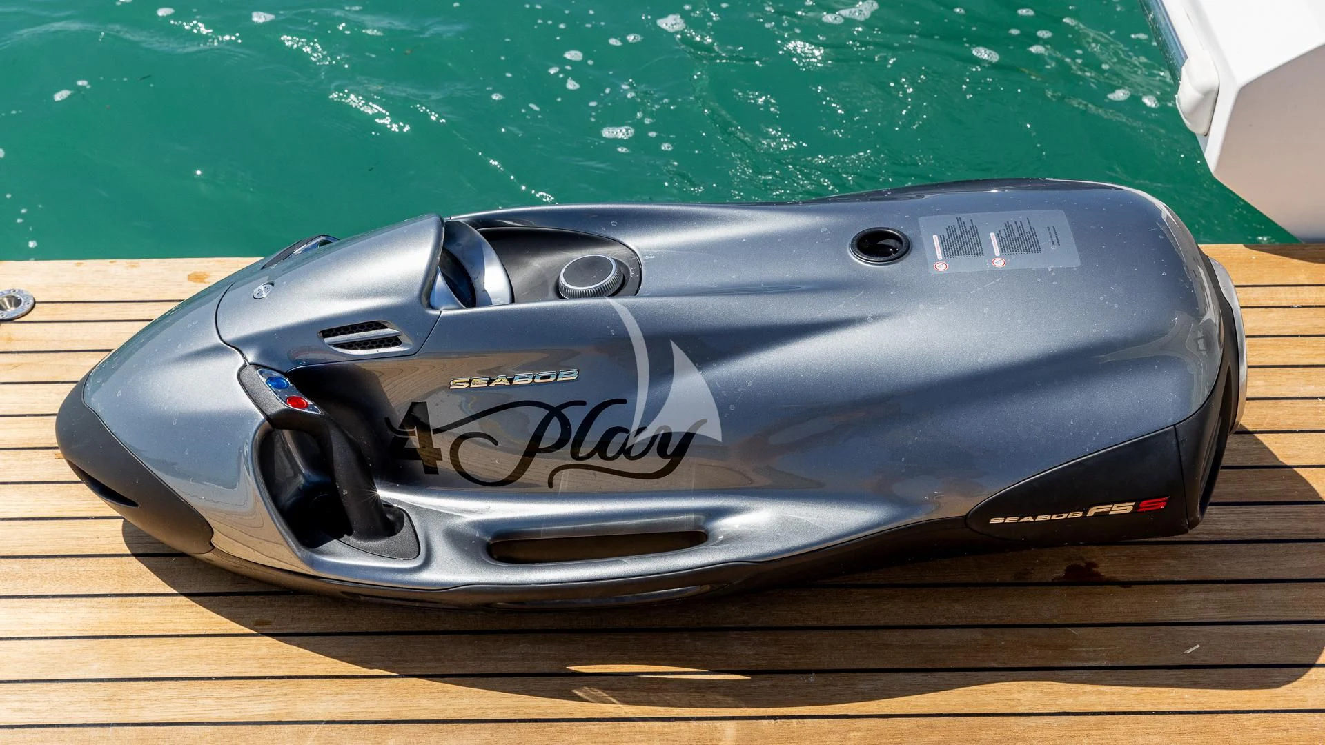 a black sports car aboard CAPTAIN MORGAN II Yacht for Sale