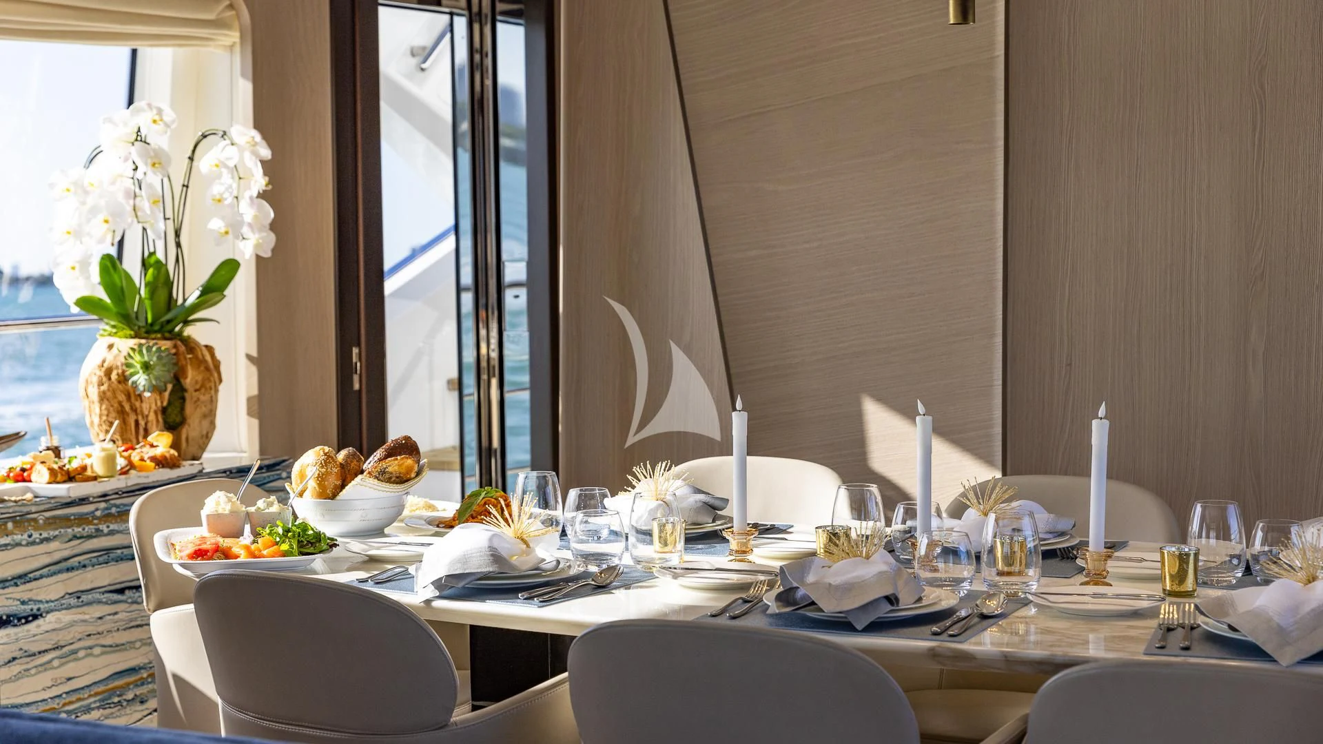 a table with plates and glasses aboard CAPTAIN MORGAN II Yacht for Sale