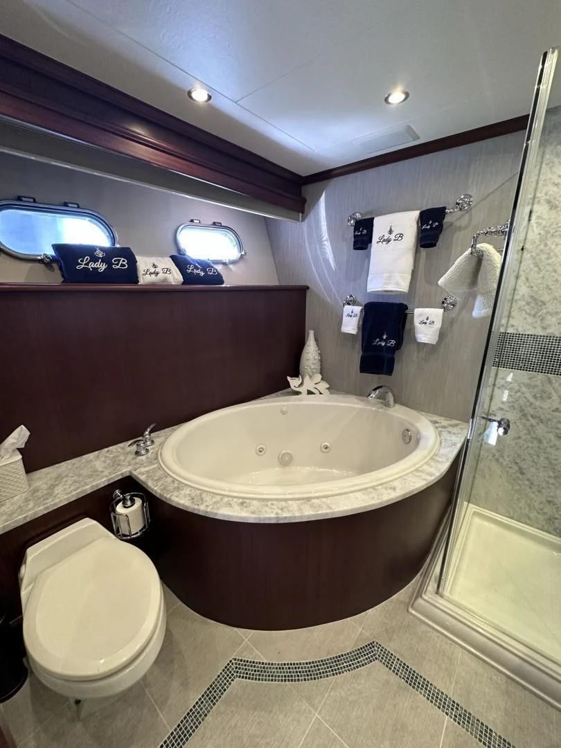 a bathroom with a tub and toilet aboard LADY B Yacht for Sale
