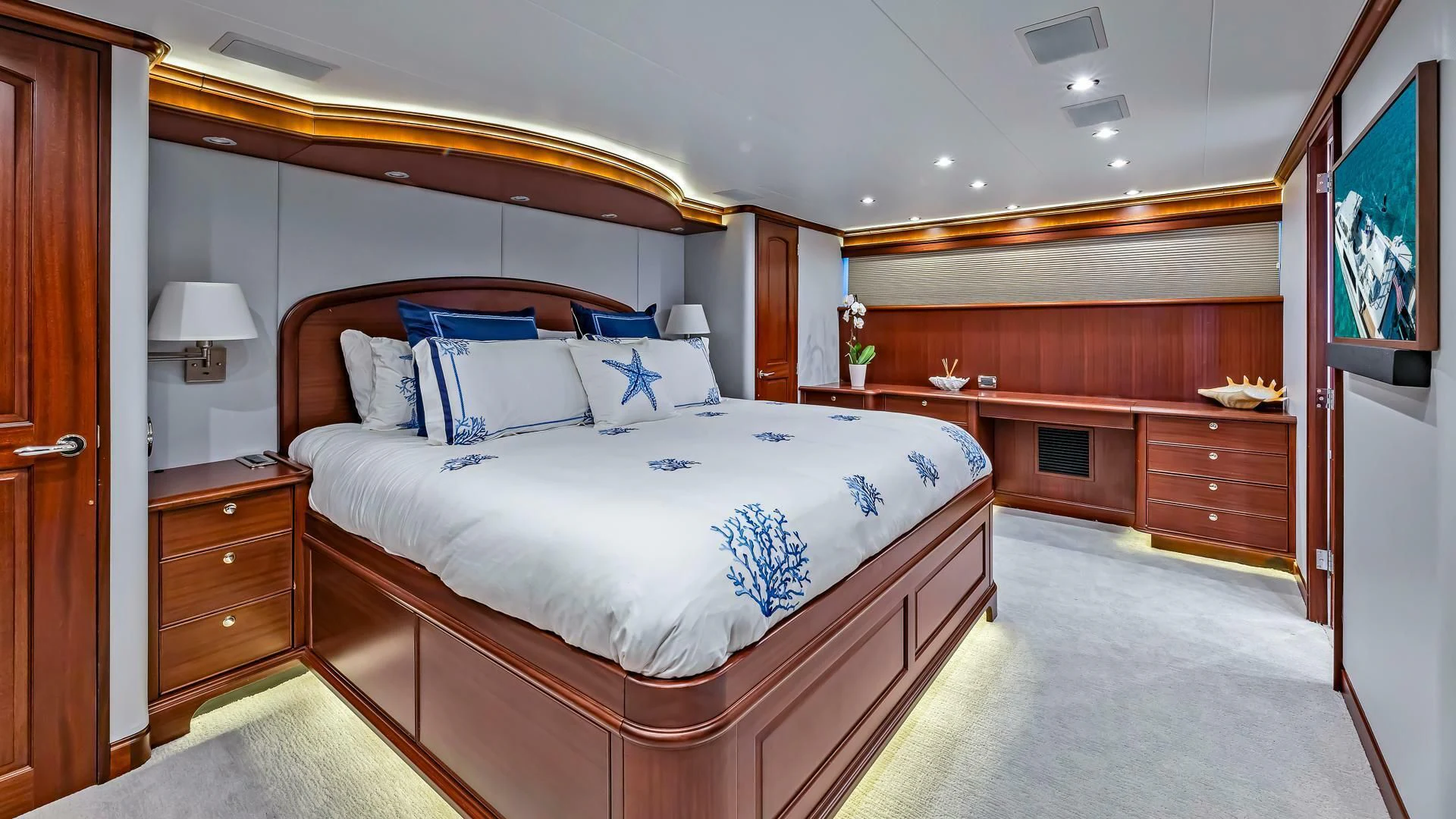 a bedroom with a bed and a desk aboard LADY B Yacht for Sale