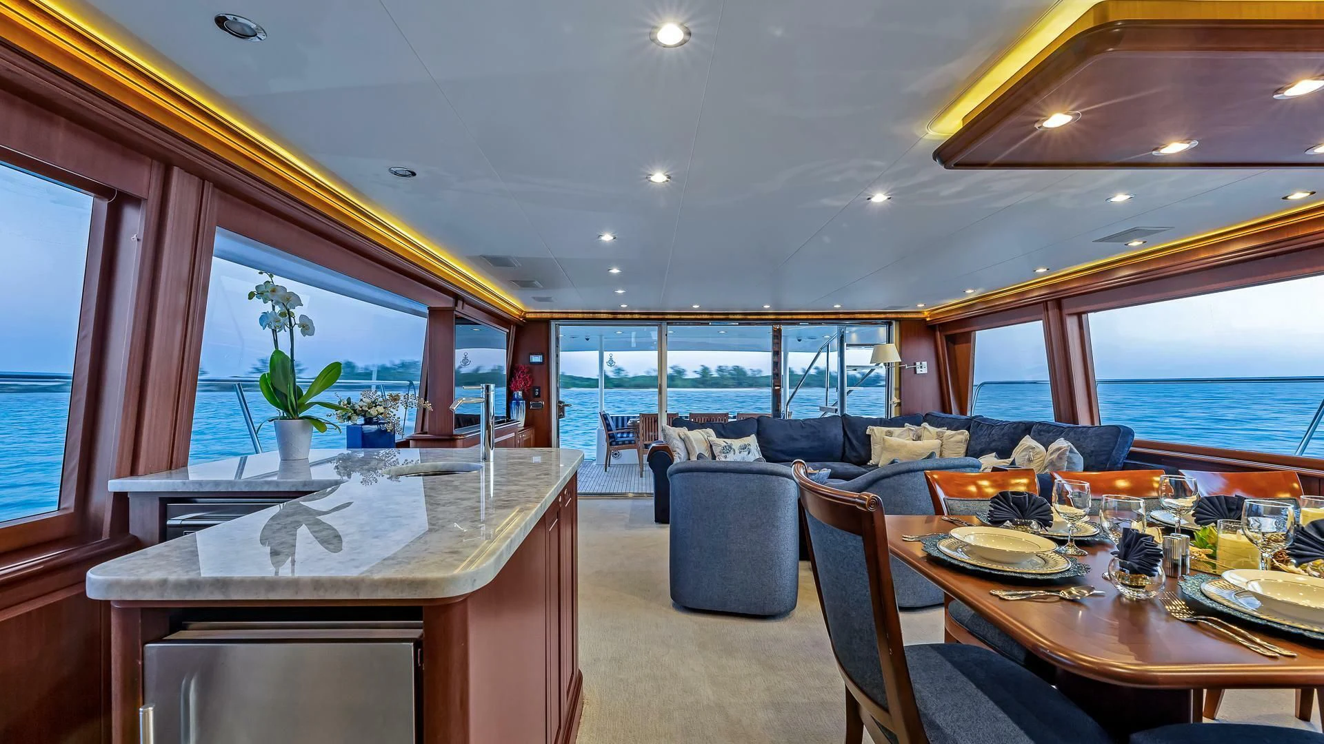 a dining room with a large window aboard LADY B Yacht for Sale