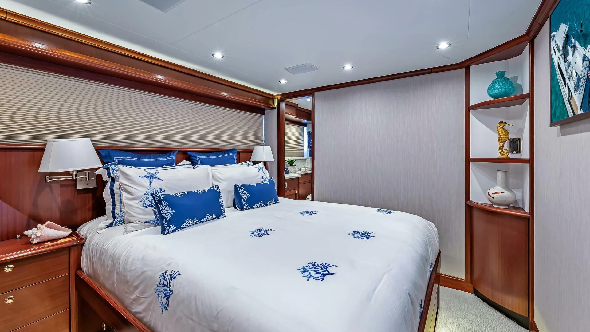 a bedroom with a bed and a mirror aboard LADY B Yacht for Sale