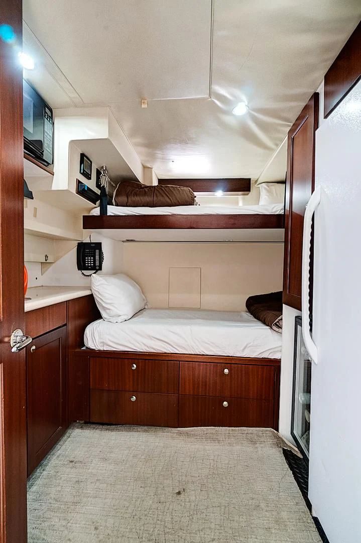 a bed with a mirror above it aboard LADY B Yacht for Sale
