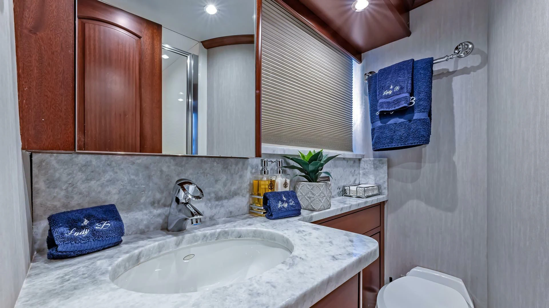 a bathroom with a sink and a mirror aboard LADY B Yacht for Sale