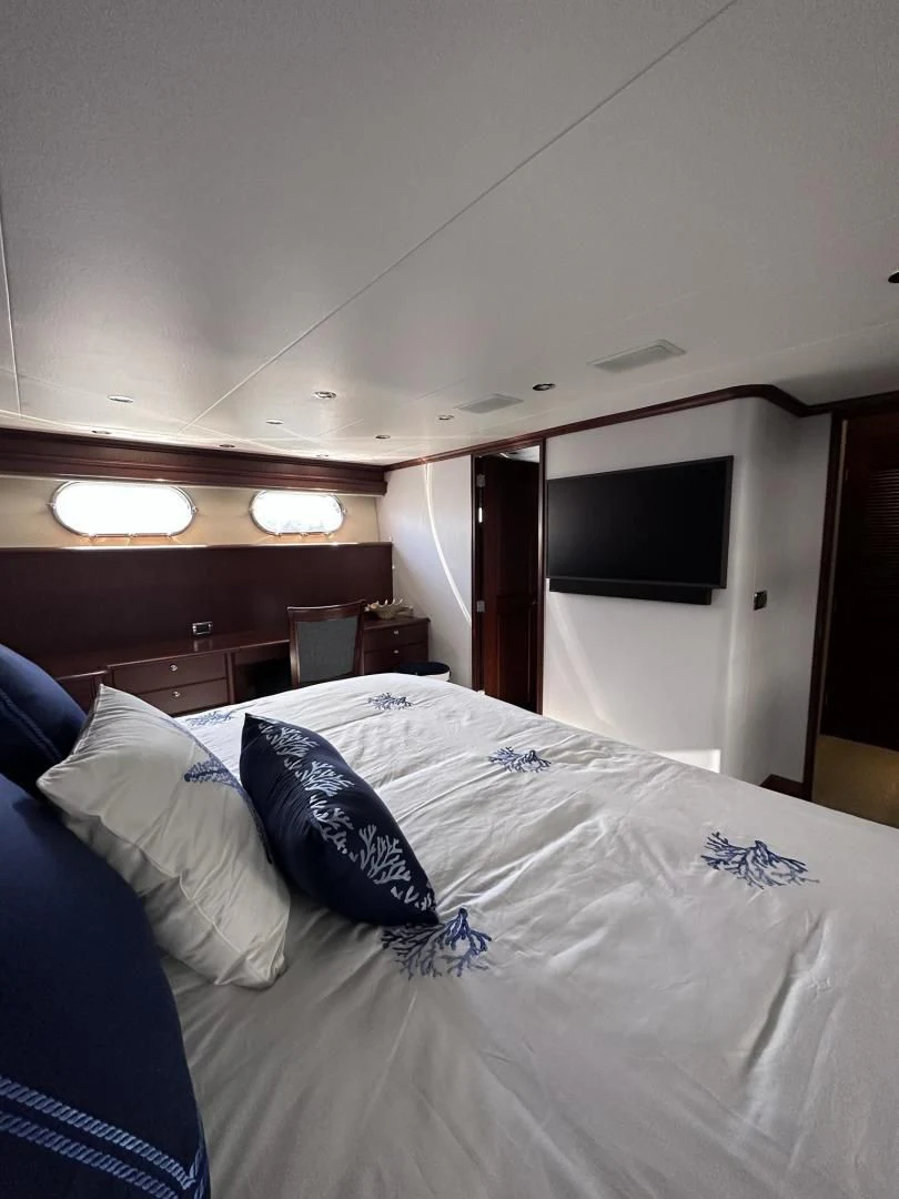 a bed with a white comforter and pillows aboard LADY B Yacht for Sale