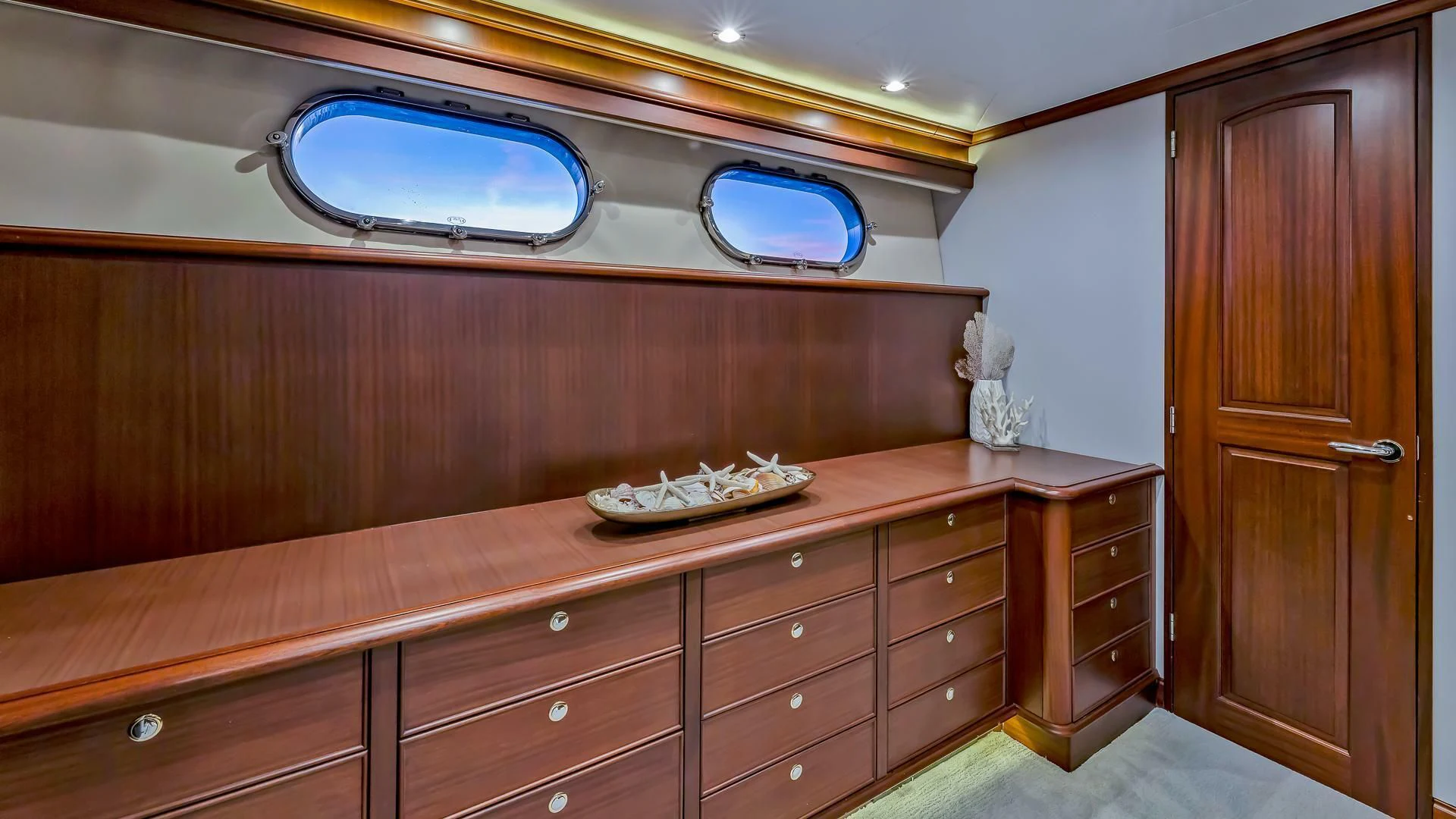 a room with a large mirror and a counter with a sink and cabinets aboard LADY B Yacht for Sale