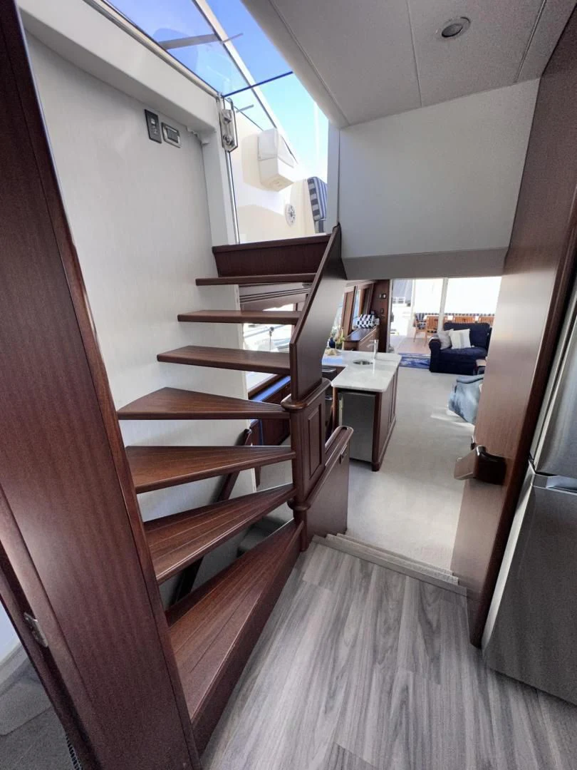 a room with wooden stairs aboard LADY B Yacht for Sale
